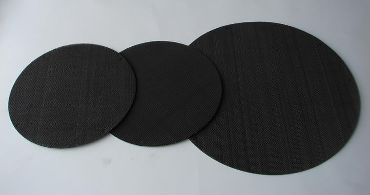 Three different sizes of black circular multi layer extruder screens made from black wire cloth.