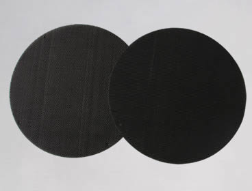 Two black circular multi layer extruder screens with spot welded edge.